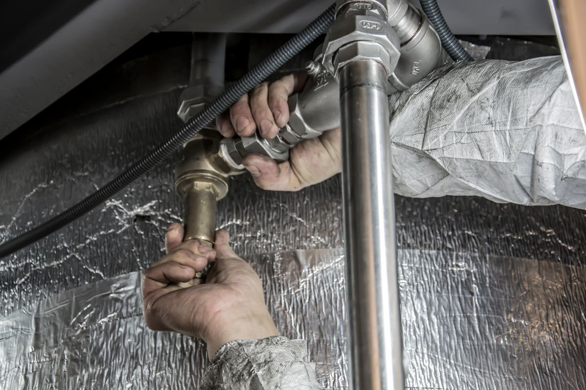 Plumber fitting water supply pipes and valves