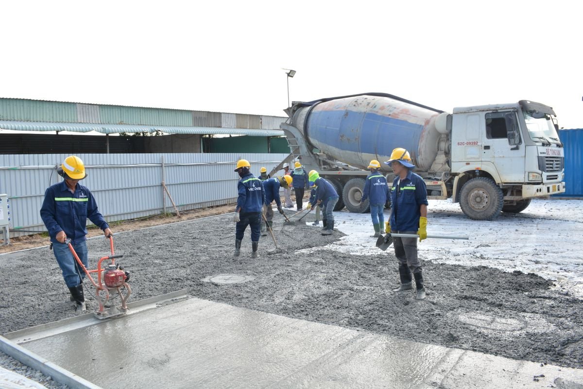 Ready-mix concrete truck delivering to a site crew