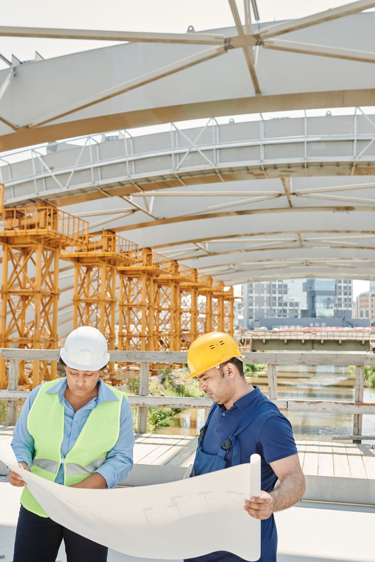 Engineers reviewing a structural drawing on site