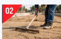 Worker screeding a level sand bedding layer