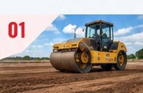 Roller compacting sub-grade soil on a road construction site