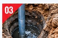Water visible at the bottom of a soil test bore hole