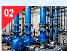Blue pumps and vertical process piping inside a plant room
