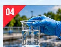 Gloved hand holding a beaker of treated water sample